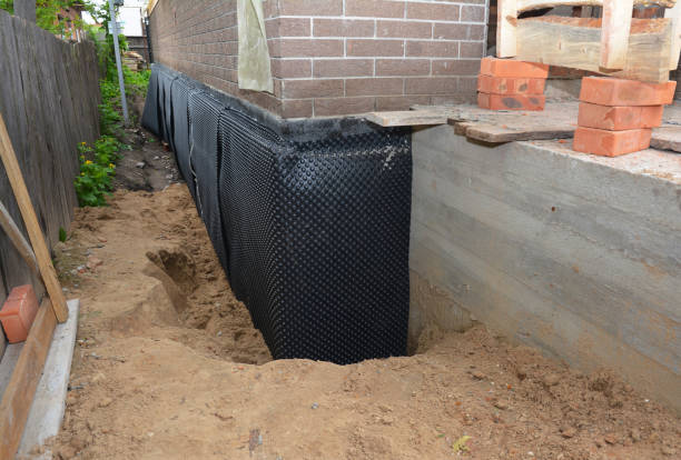 Happy homeowners after waterproofing job in Hunt